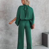 Elegante tuta verde smeraldo con maniche lunghe autunnali